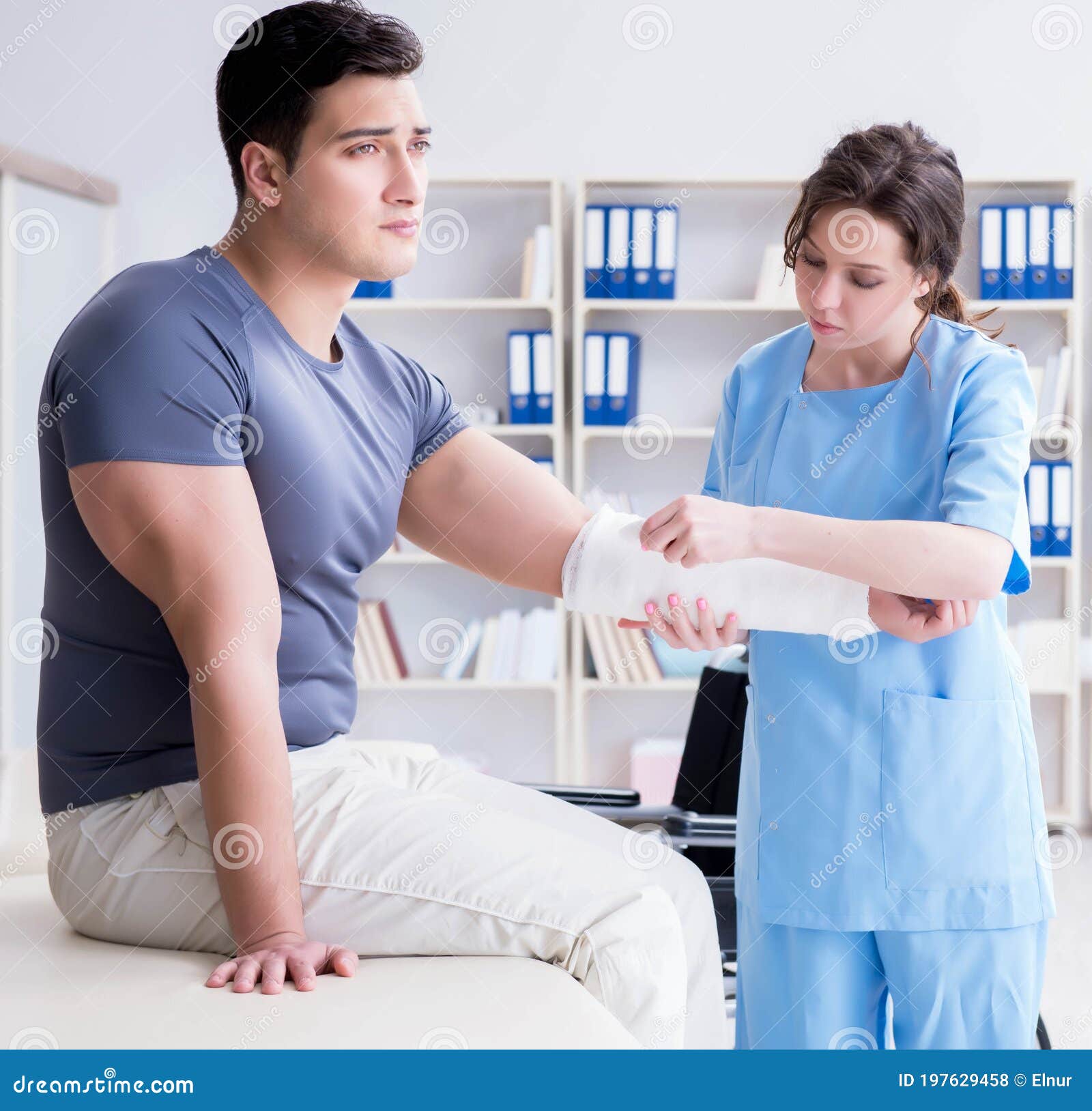 Doctor And Patient During Check Up For Injury In Hospital Stock Photo