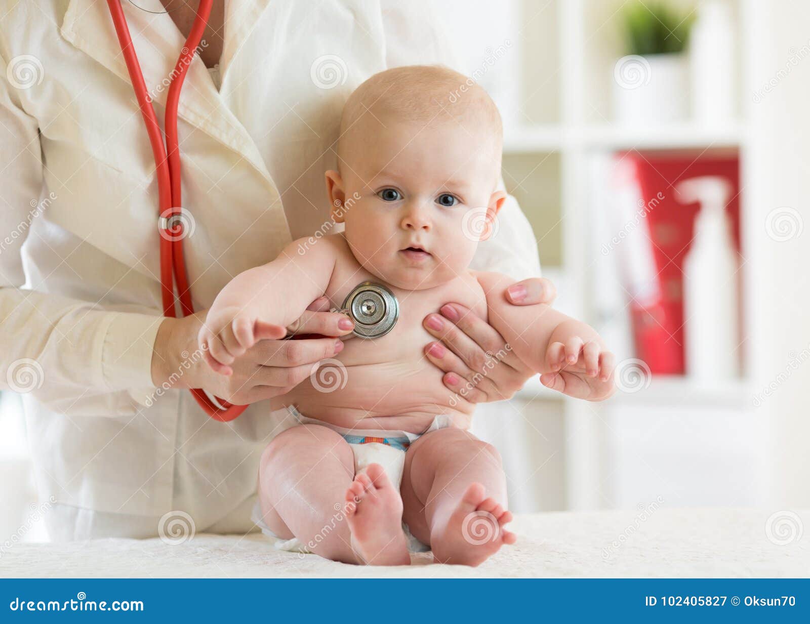 doctor pediatric examining little child in clinic. baby health concept