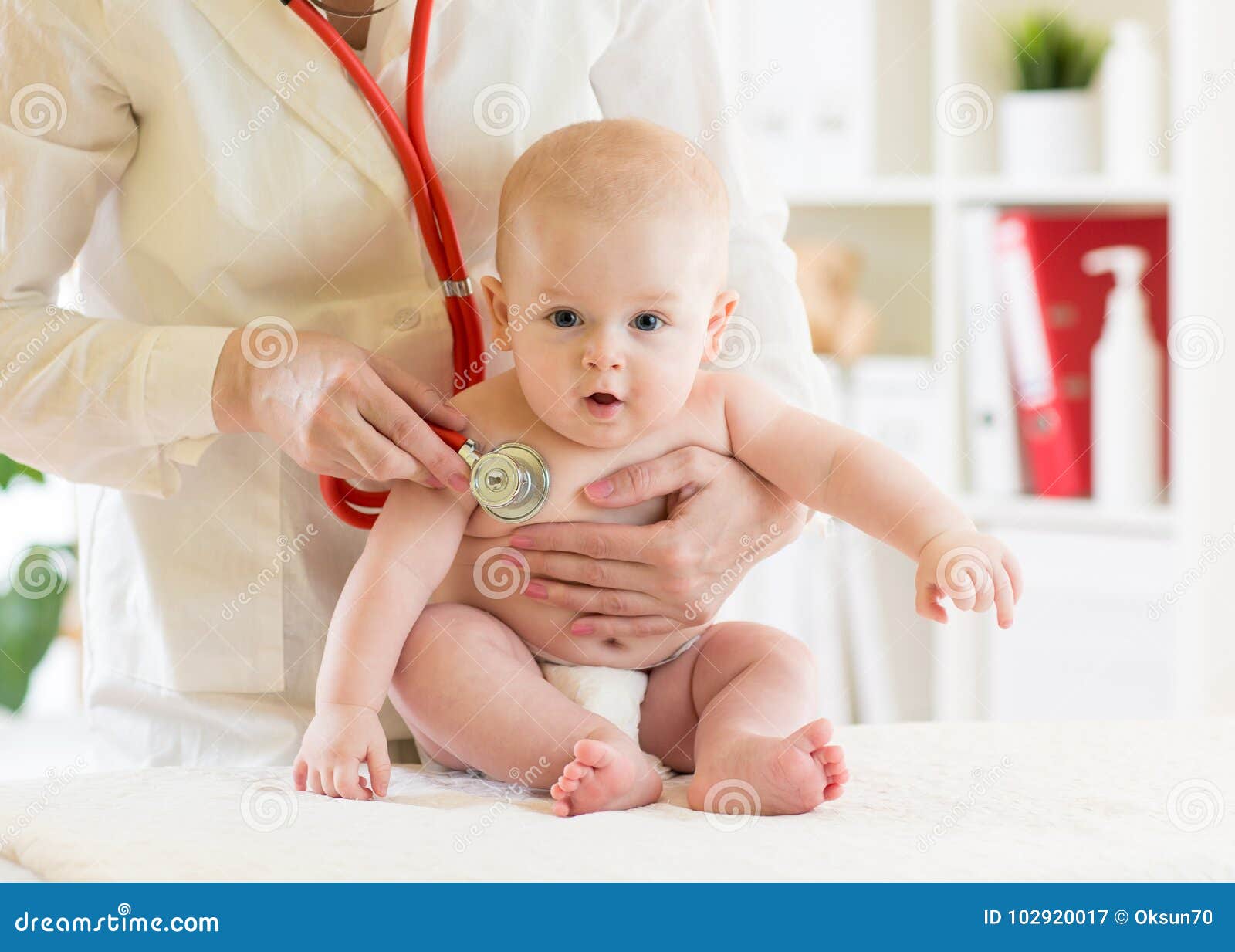 doctor pediatric examining little baby in clinic. baby health concept