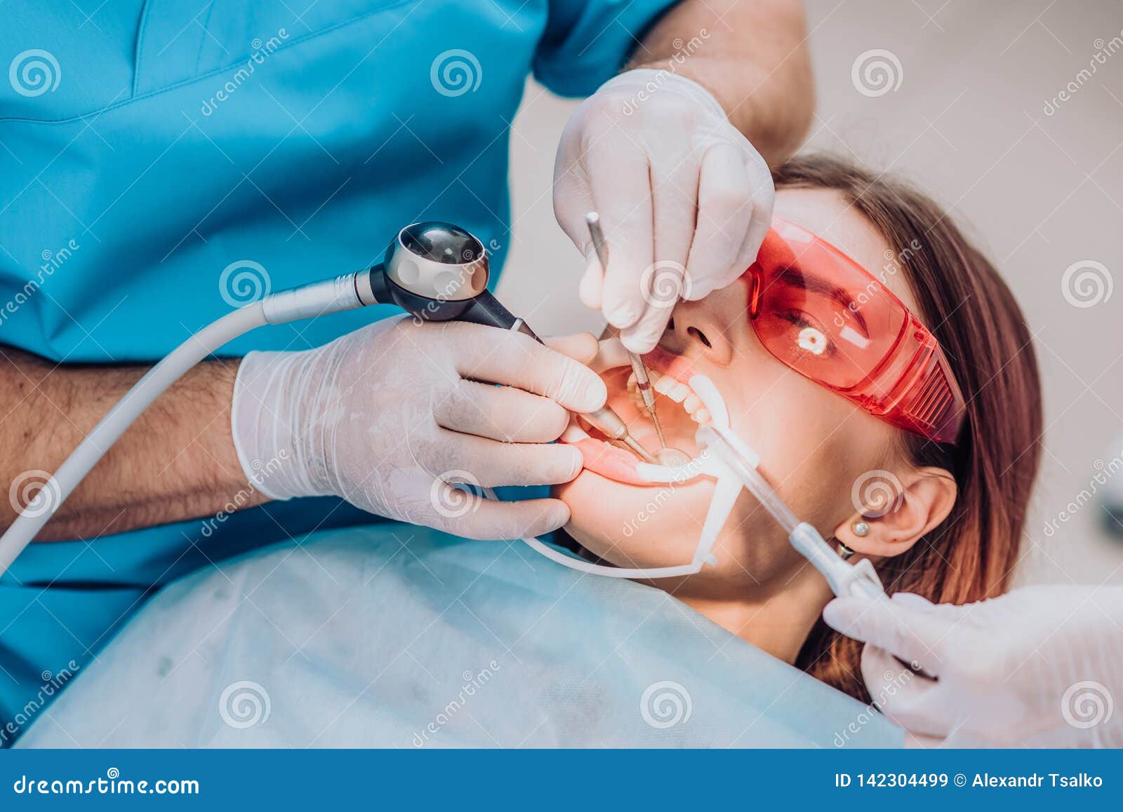Doctor Orthodontist Performs a Procedure for Cleaning Teeth Stock Image
