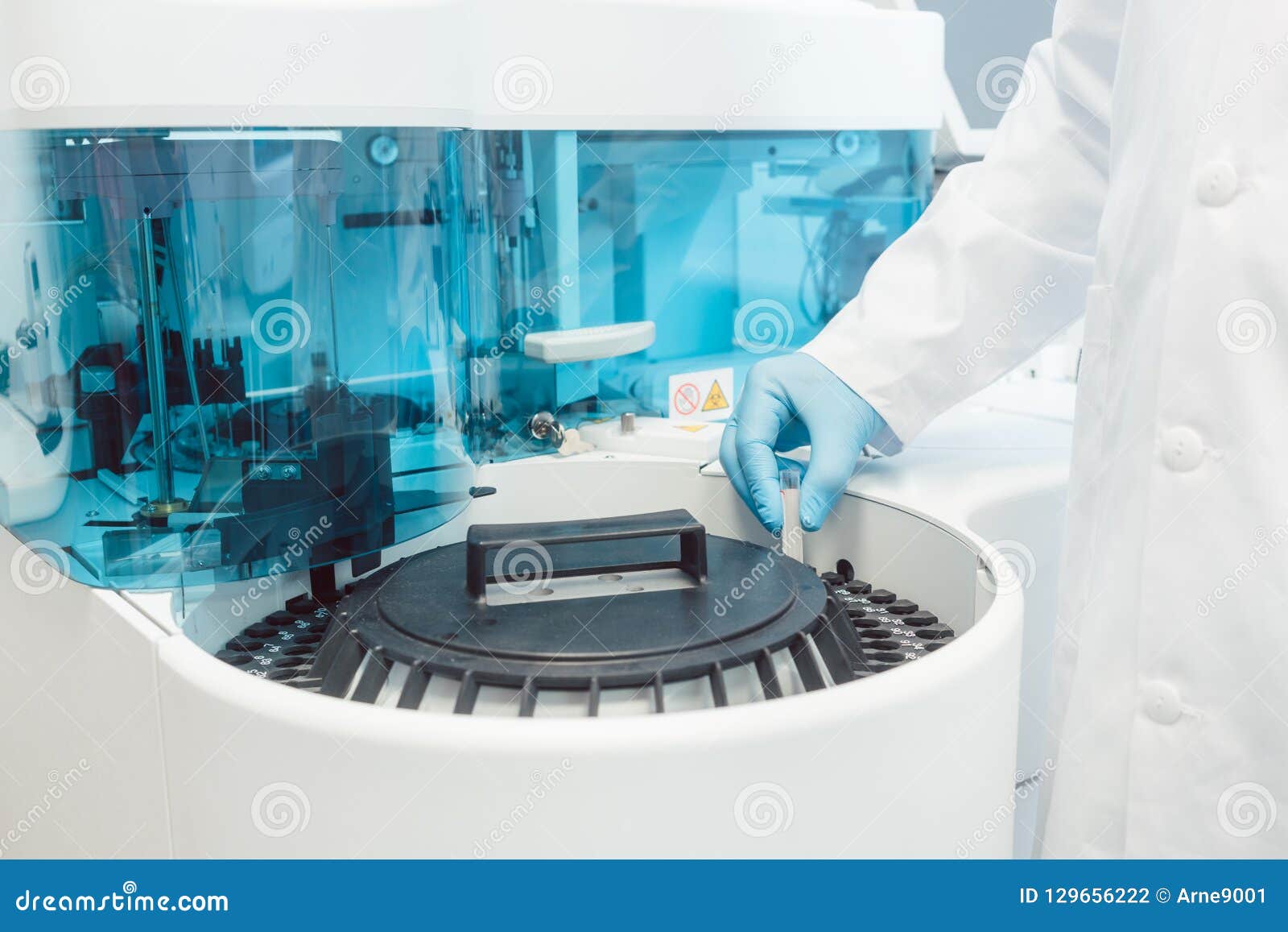 Doctor Putting Tubes of Blood in Centrifugal Machine for Testing Stock