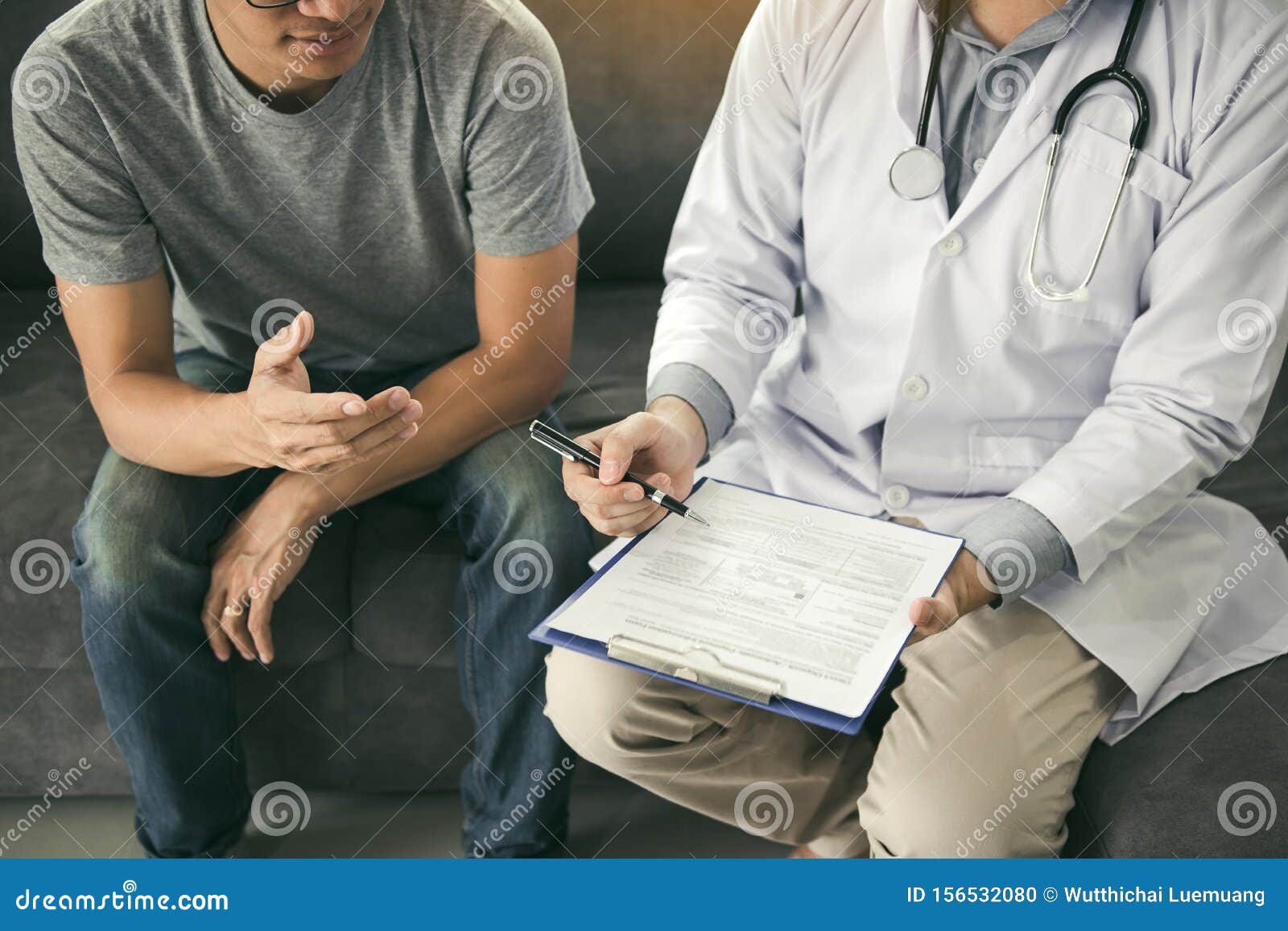 Doctor is Recording the Patient`s Information while the Patient is