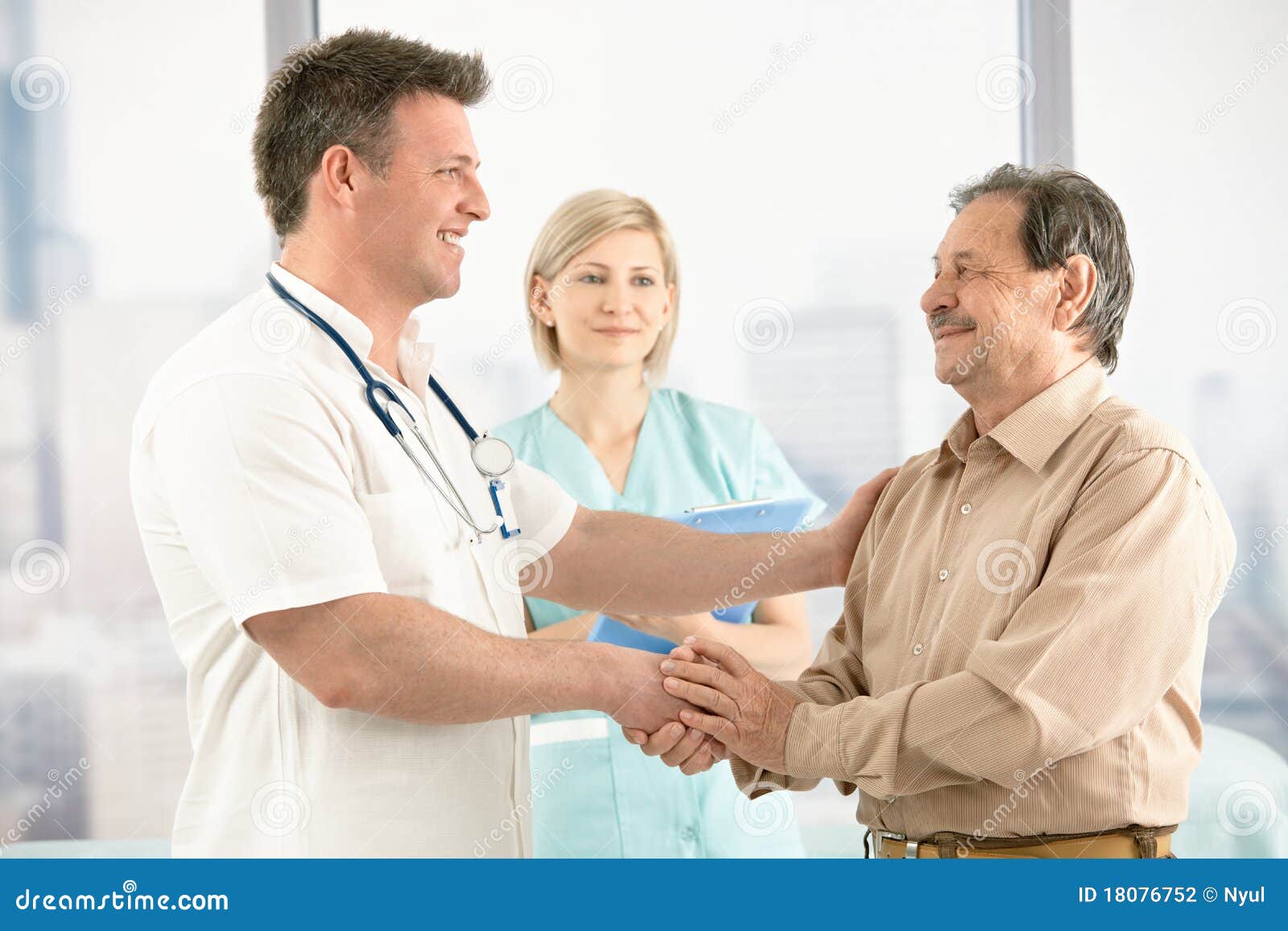 doctor shaking hands with senior patient