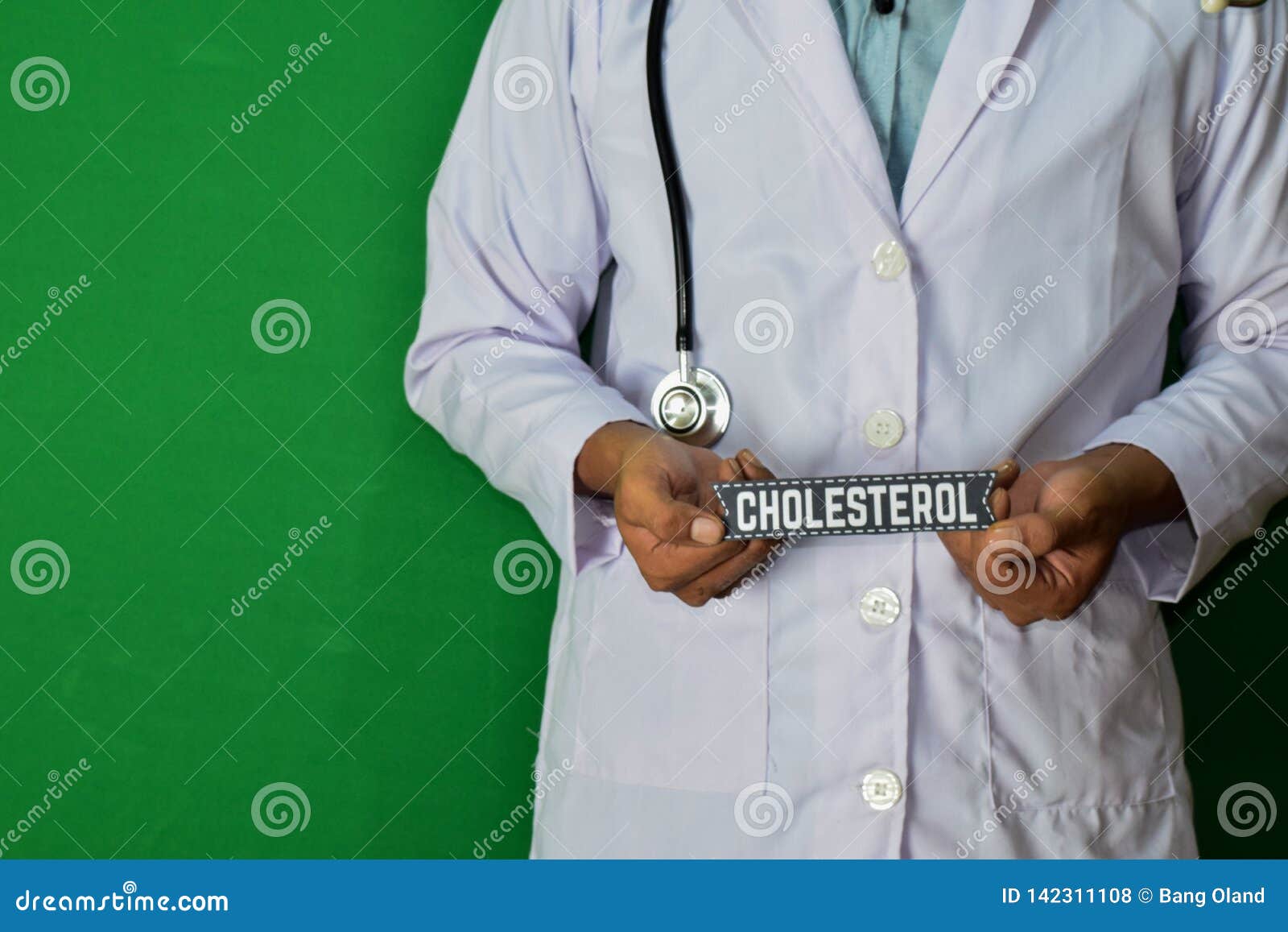 doctor standing on green background. selective focus in hand. high colesterol paper text.