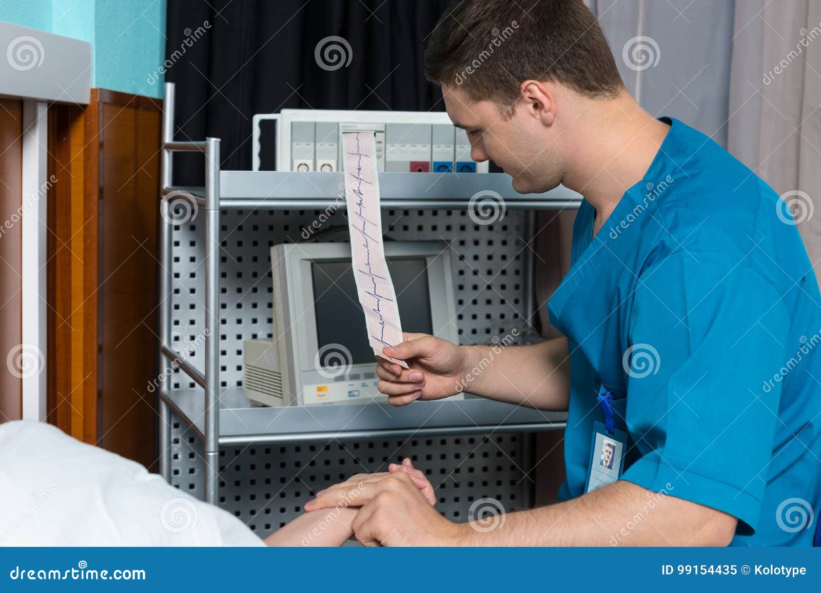 doctor in uniform is looking at analysis of electrocardiograph e