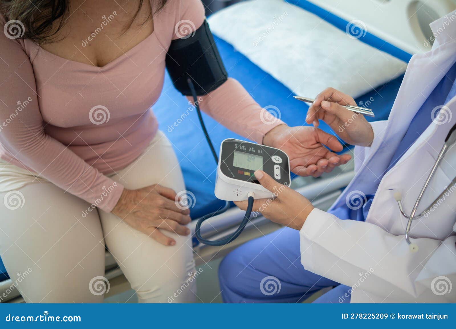 The Doctor Is Using A Blood Pressure Monitor On An Elderly Patient To