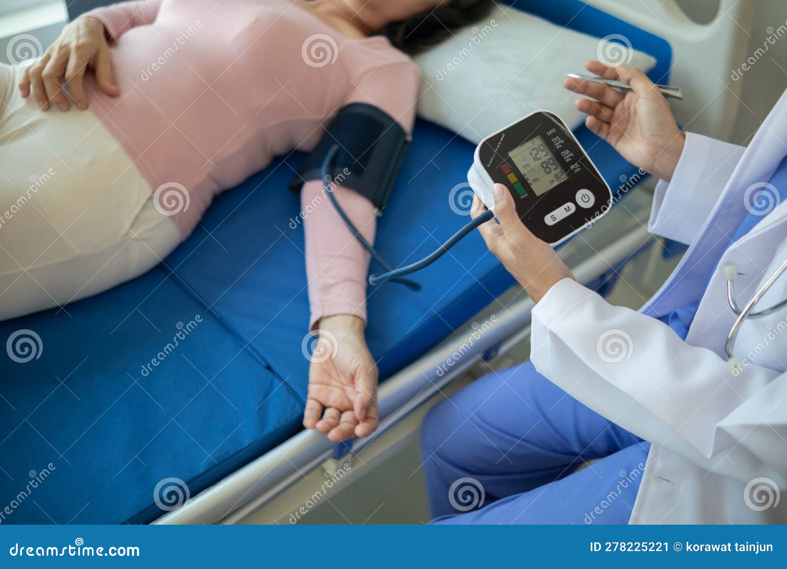 The Doctor Is Using A Blood Pressure Monitor On An Elderly Patient To