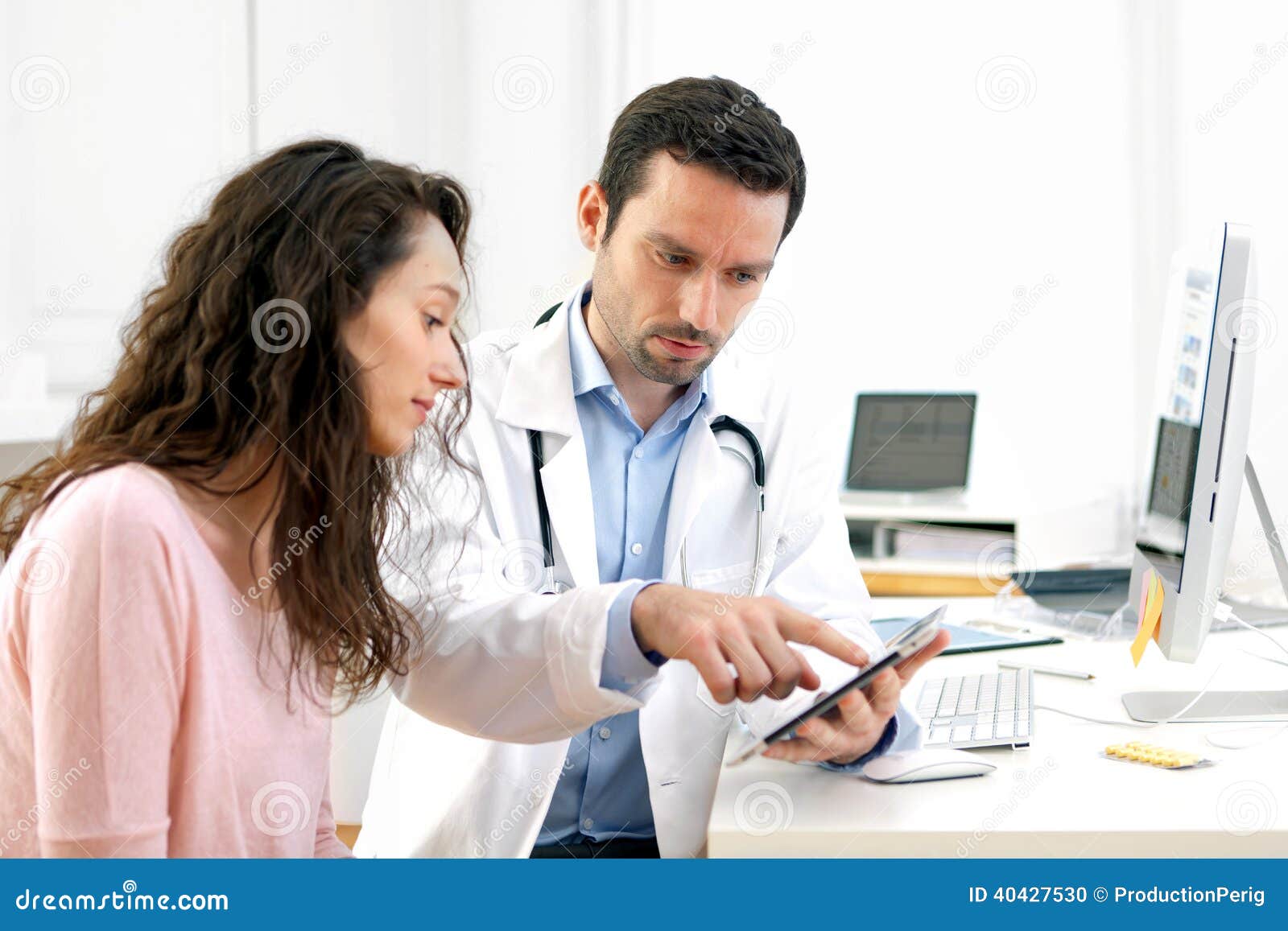 doctor using tablet to inform patient