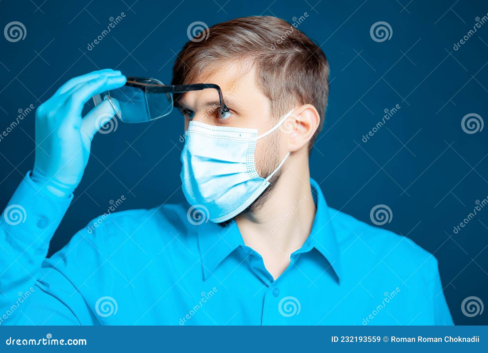 Doctor Wearing a Protective Mask and Gloves Puts on Glasses Stock Image ...