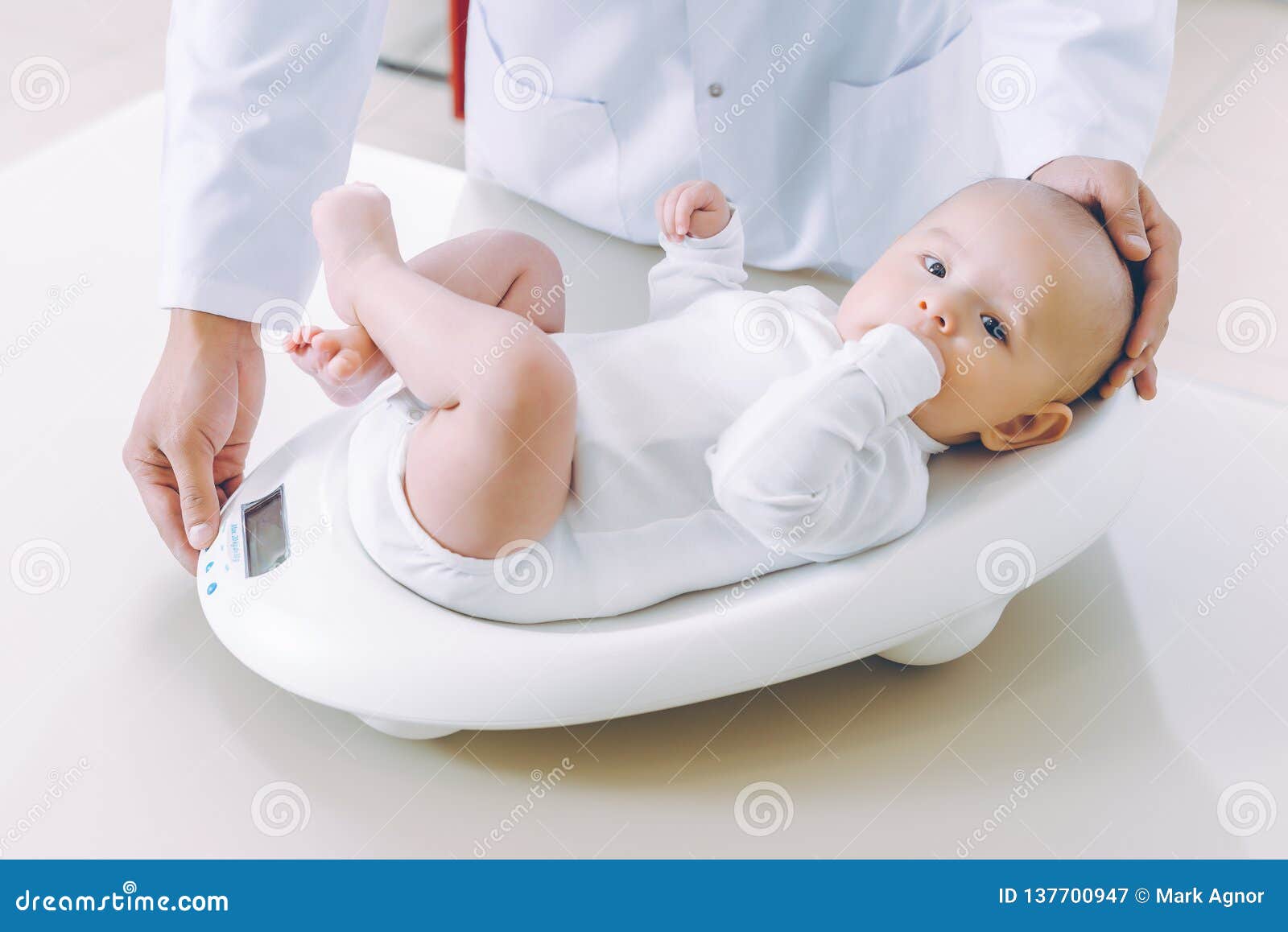 doctor weighting cute baby at home