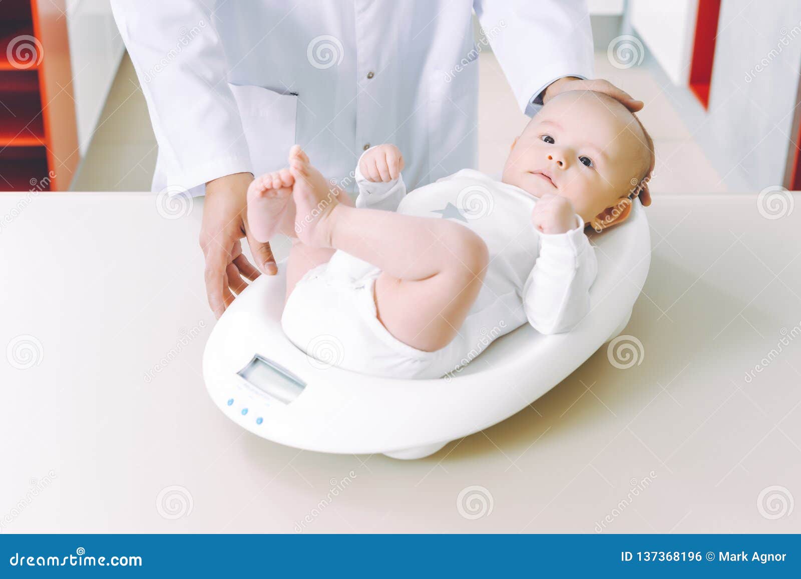 doctor weighting cute baby at home