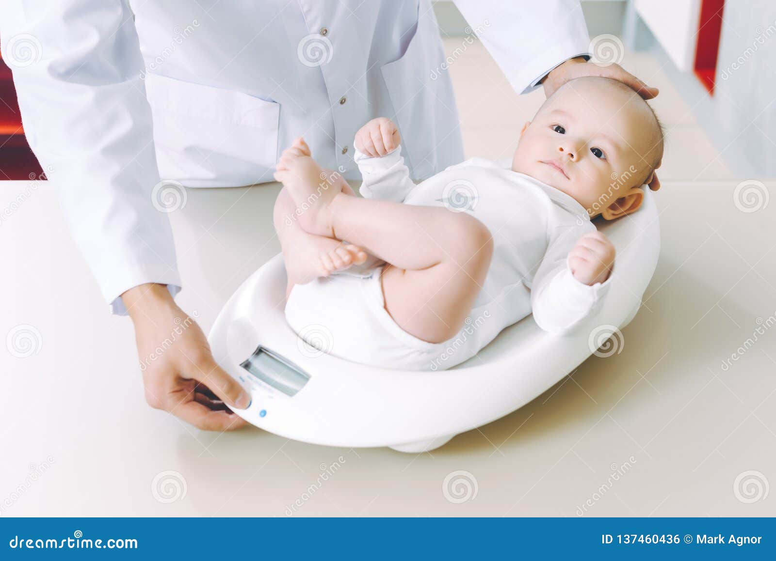 doctor weighting cute baby at home