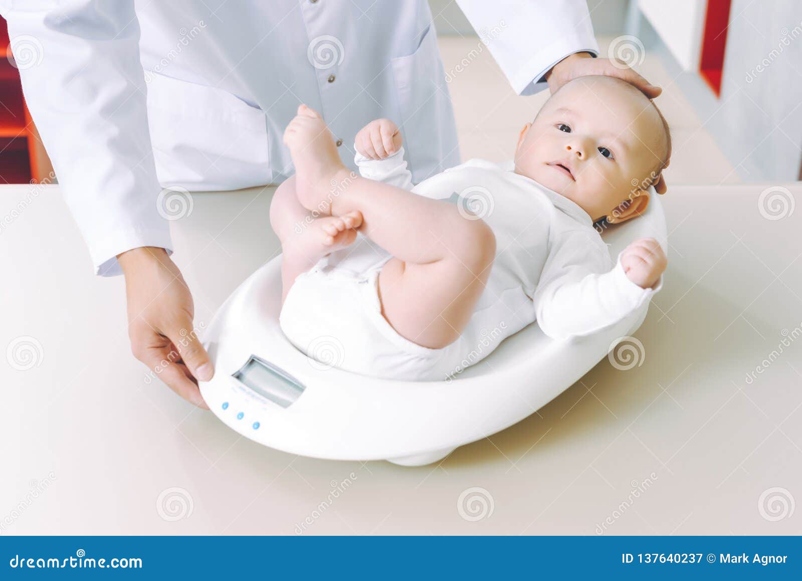 doctor weighting cute baby at home