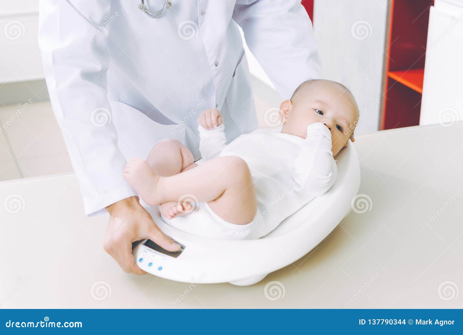 doctor weighting cute baby at home