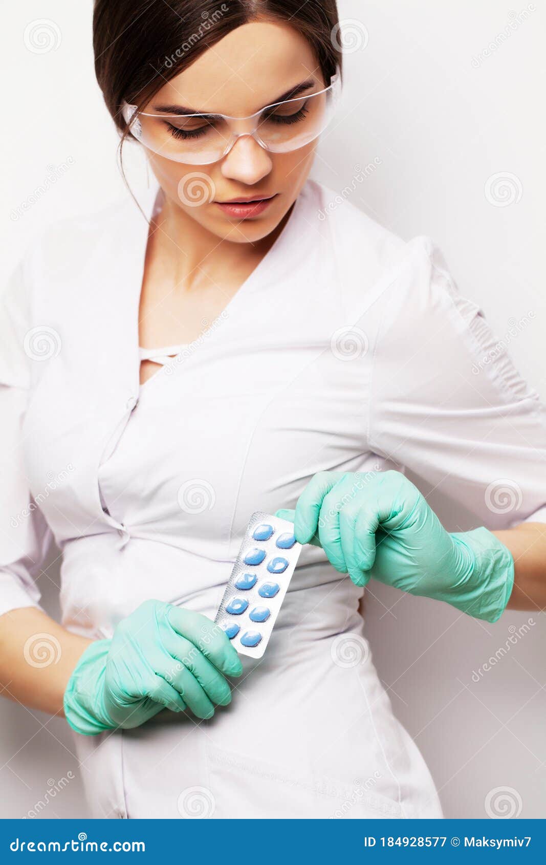 Doctor in a White Coat Holding a Pill for a Healthy Sex Life of Men Stock Image
