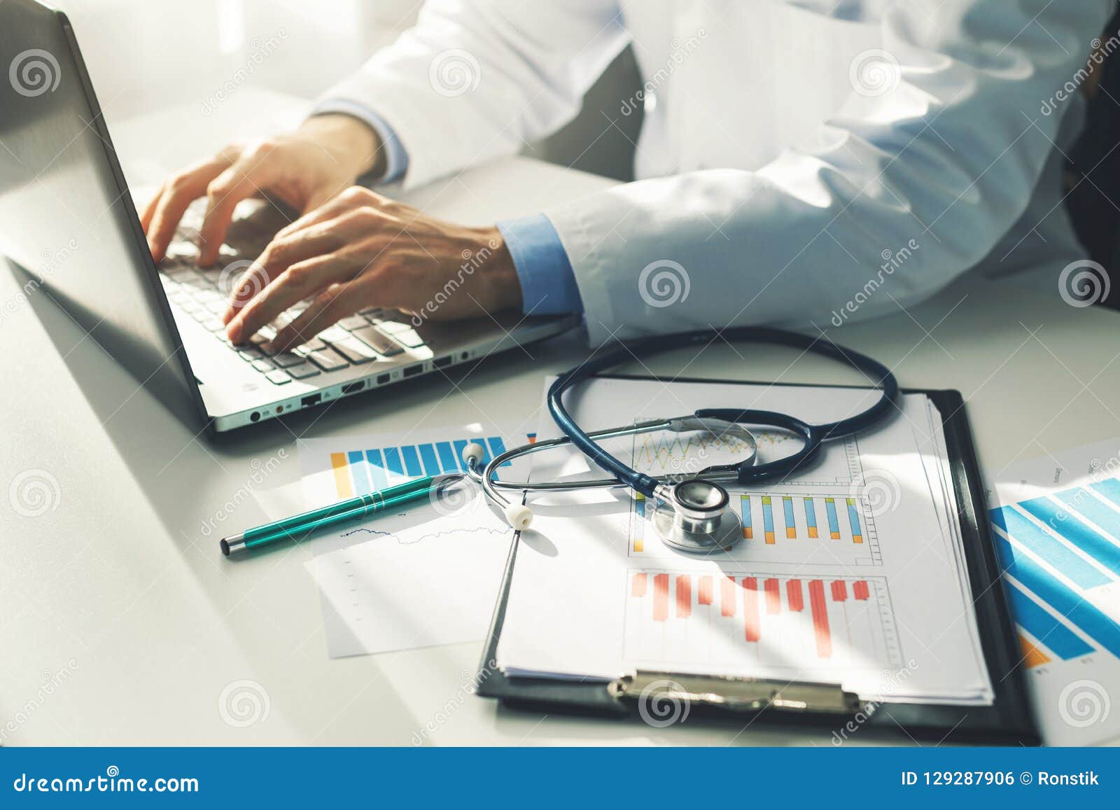 doctor working with medical statistics and financial reports