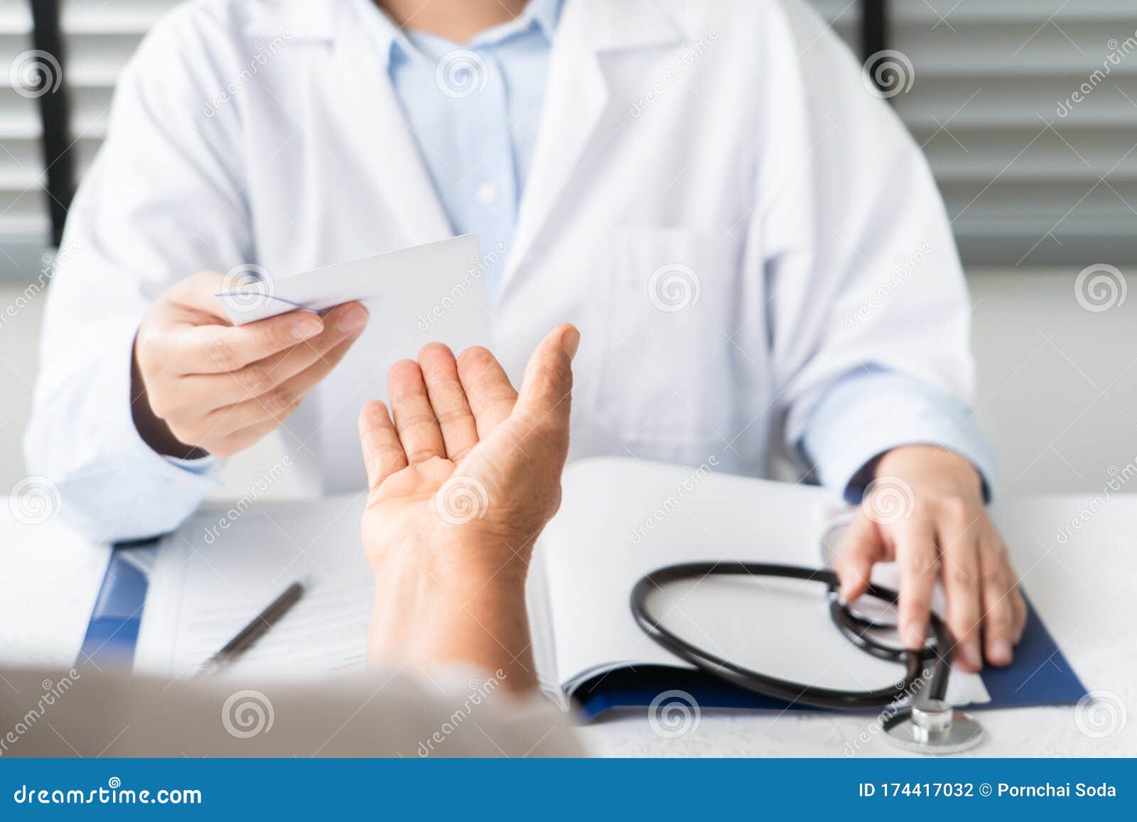 doctor writing diagnosis and giving a medical prescription to senior women patient