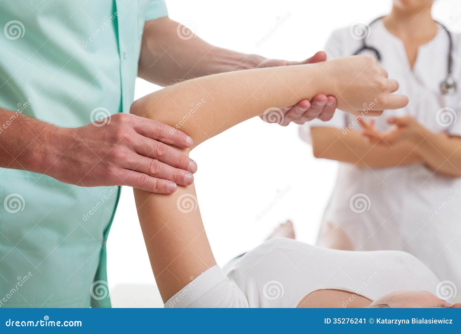 doctors examining injured arm