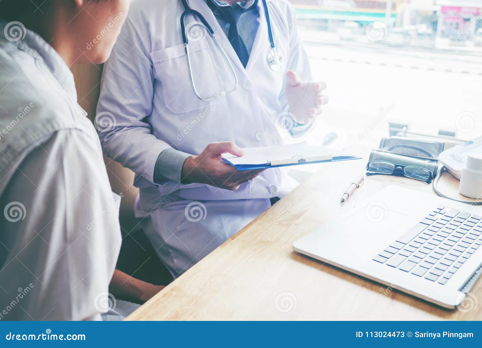 doctors and patients sit and talk. at the table near the window