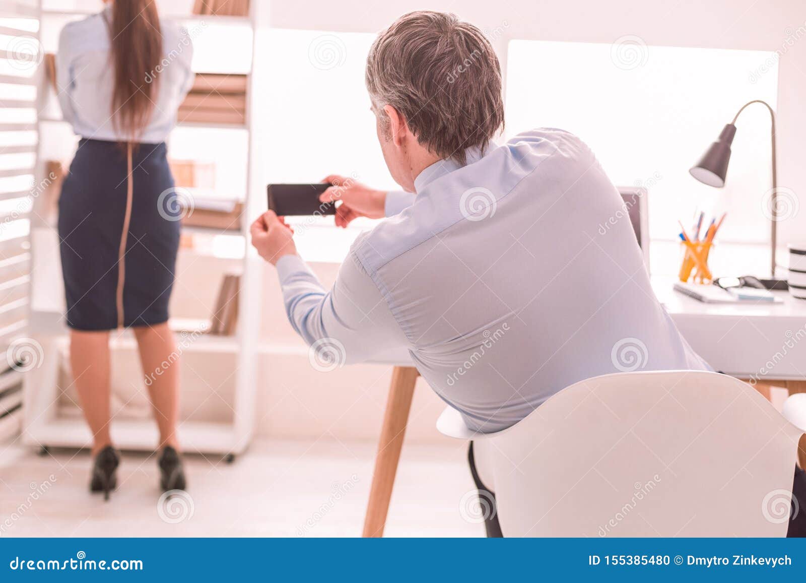 Boss Secretly Taking Pictures Of His Secretary Stock Photo Image Of