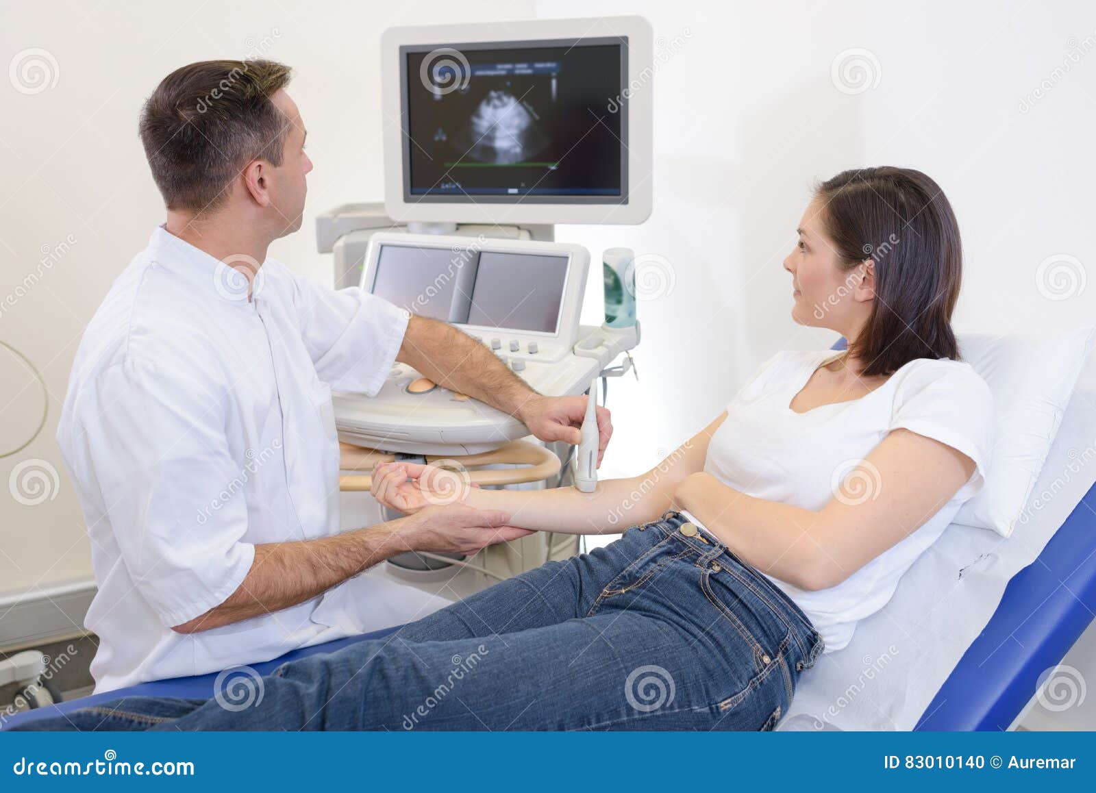 Doing ultrasound on arm stock photo. Image of insurance 83010140