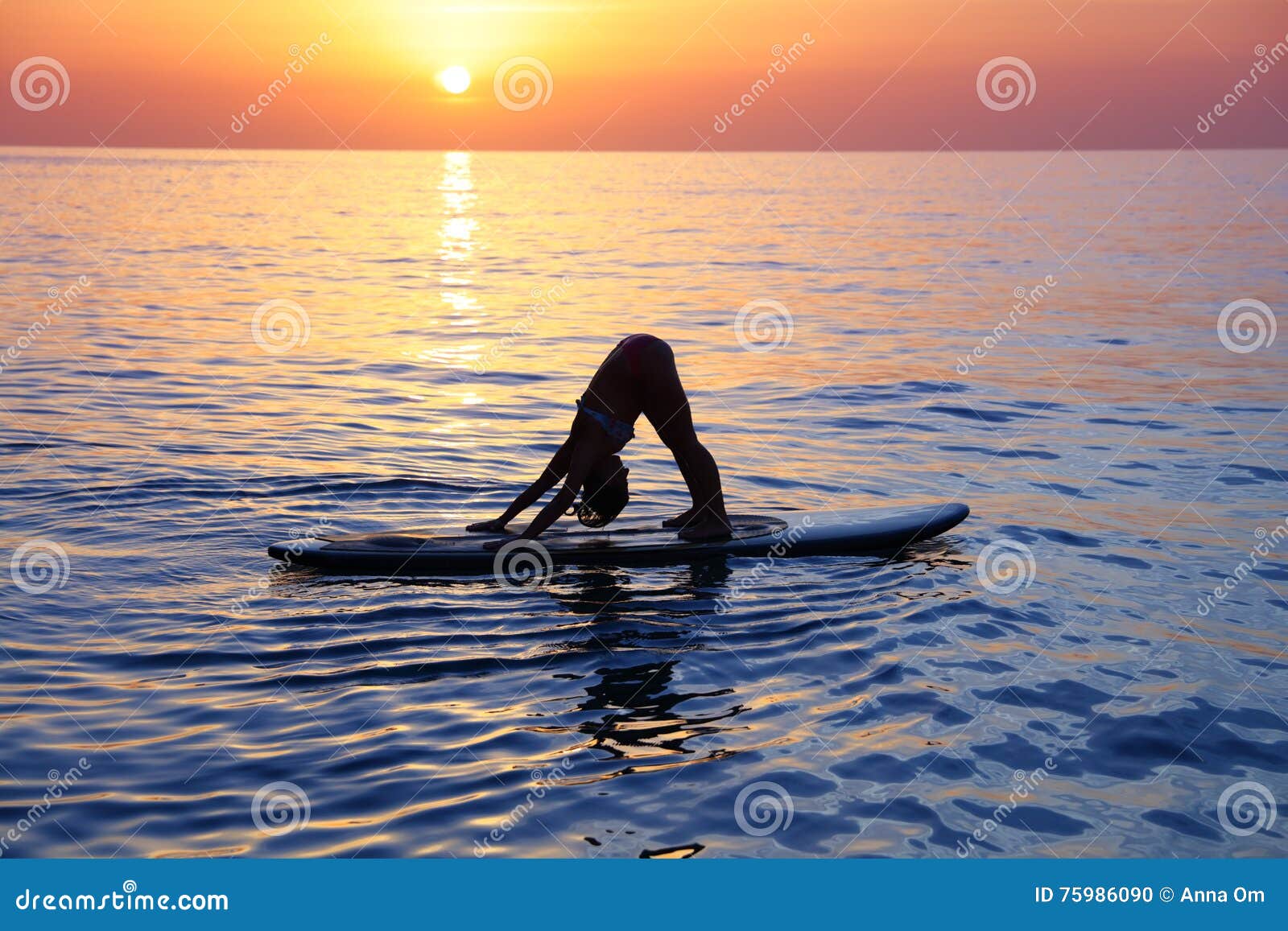 Doing yoga on the beach stock photo. Image of gymnastics - 75986090