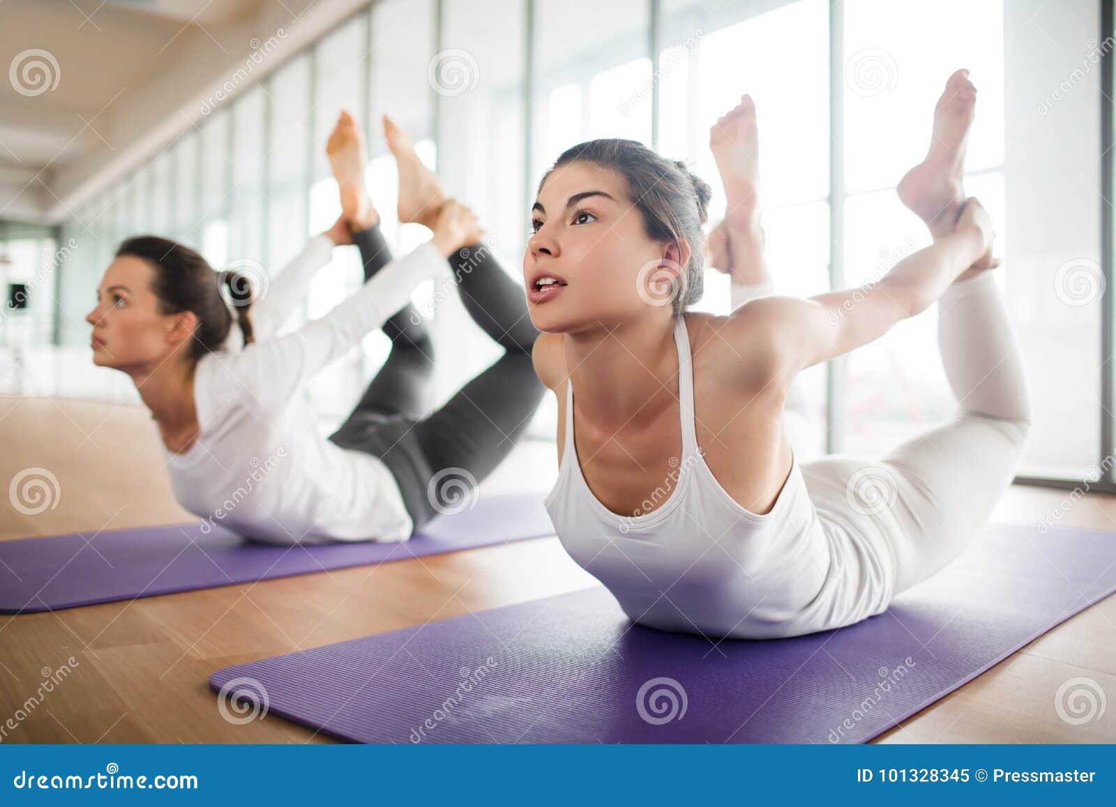 Doing Yoga Bow Pose stock image. Image of indoors, sportswear - 101328345