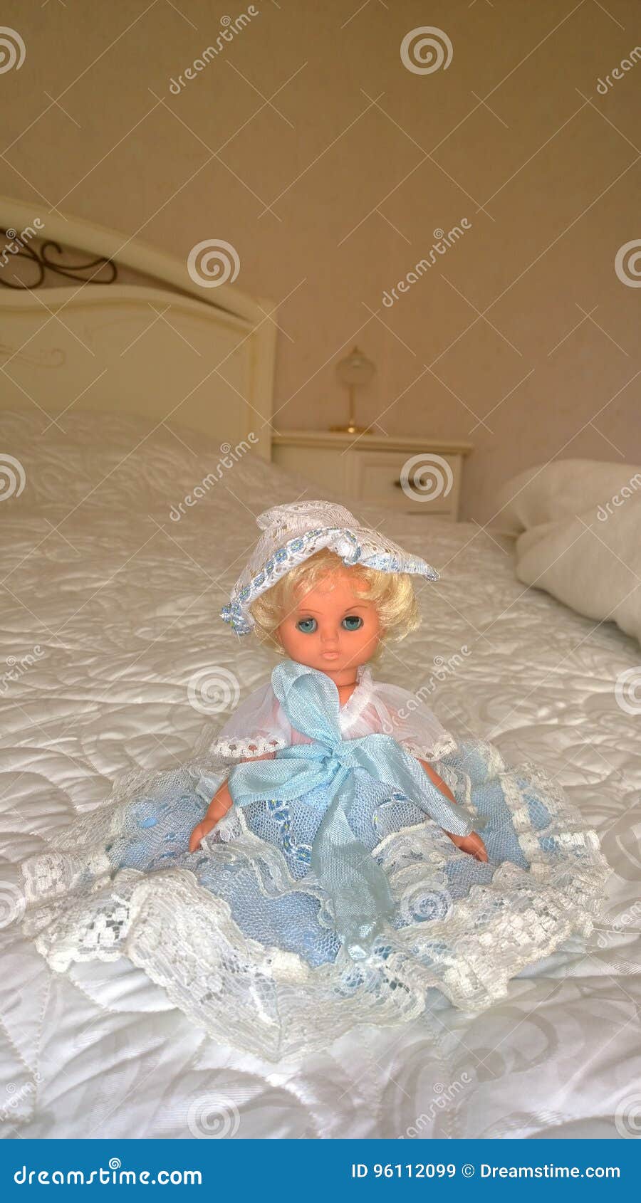 A doll on the bed stock image. Image of home, doll, dress 96112099