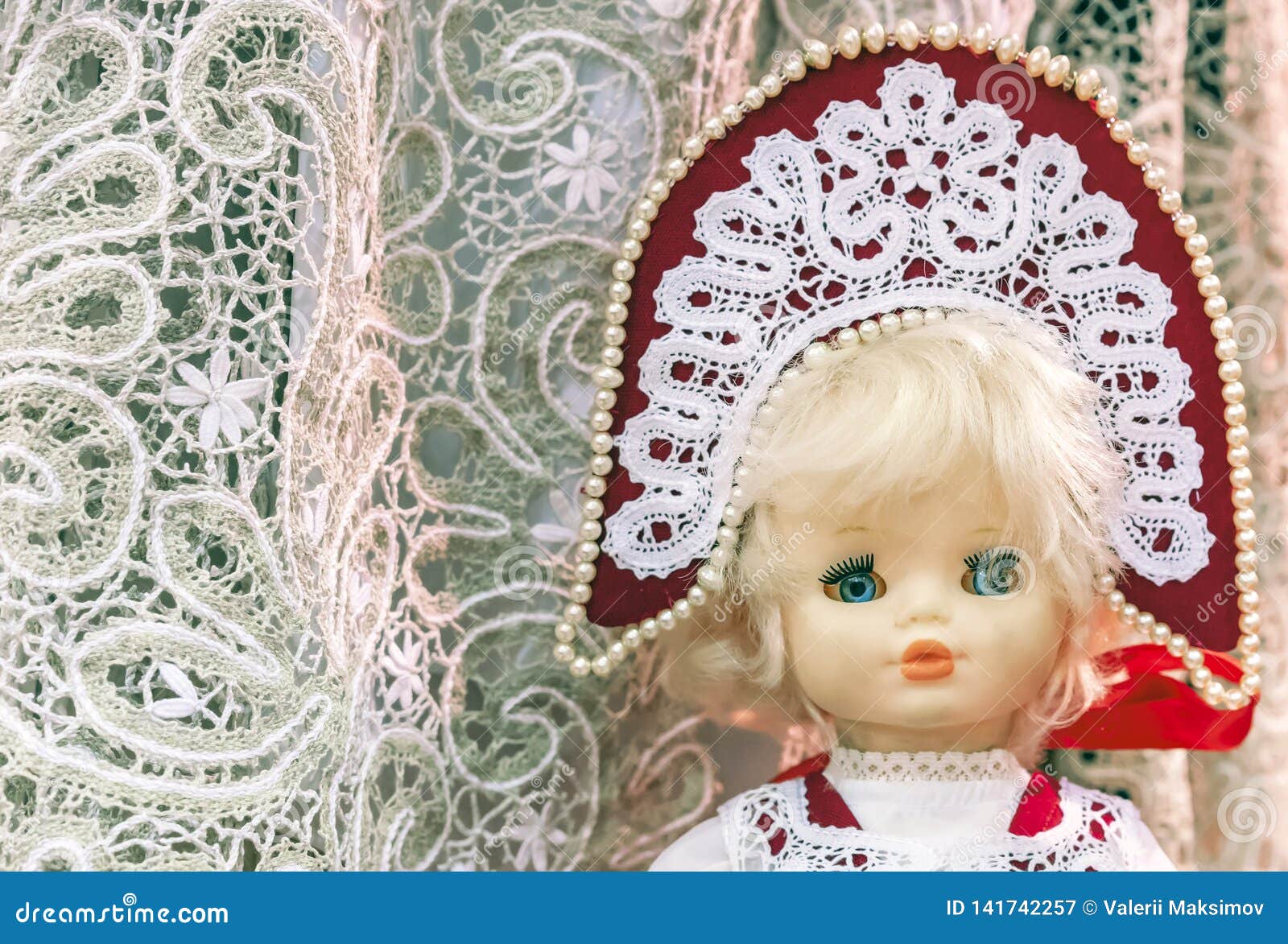 Doll in the National Russian Costume on a Lace Background Stock Image