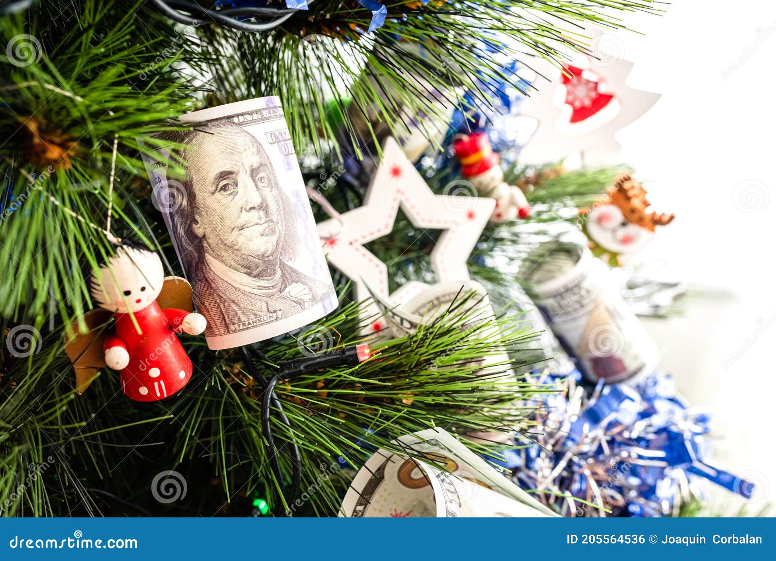 Dollar Bills Hanging on a Christmas Tree Alongside Traditional