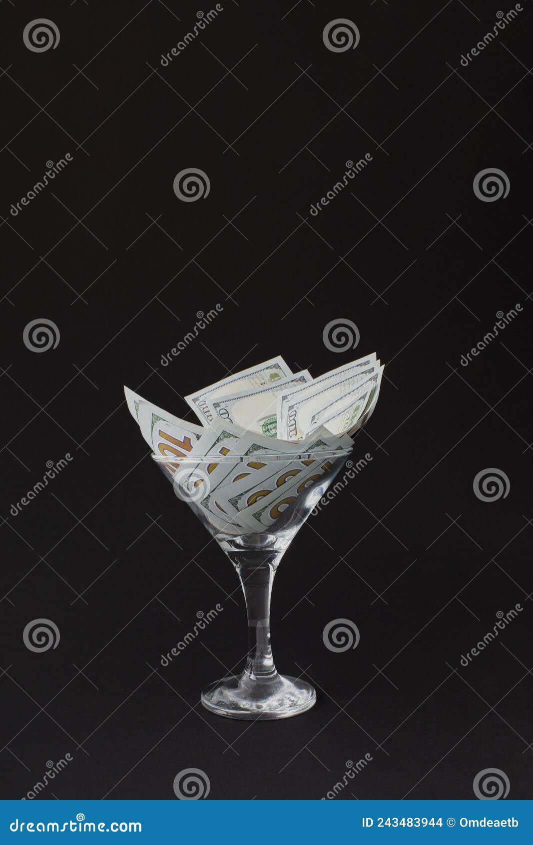 Dollar in Martini Glass. Glass is Full Hundred Dollar Bills Stock Photo