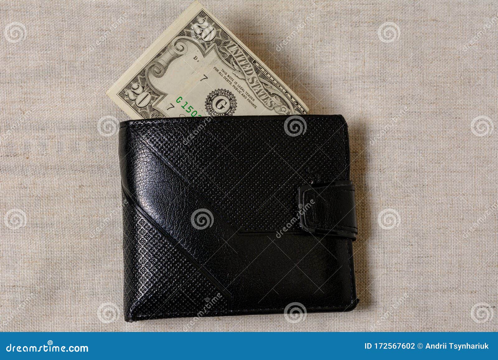 20 Dollars Sticking Out of a Wallet of Dark Leather on a Gray ...
