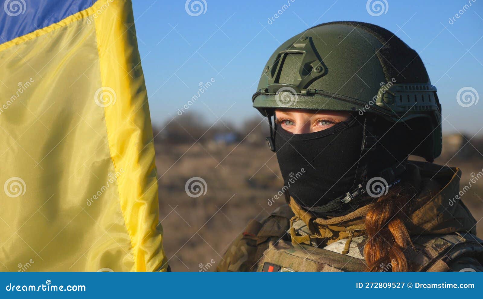 Dolly Shot of Girl in Military Helmet and Balaclava Holds a Waving ...