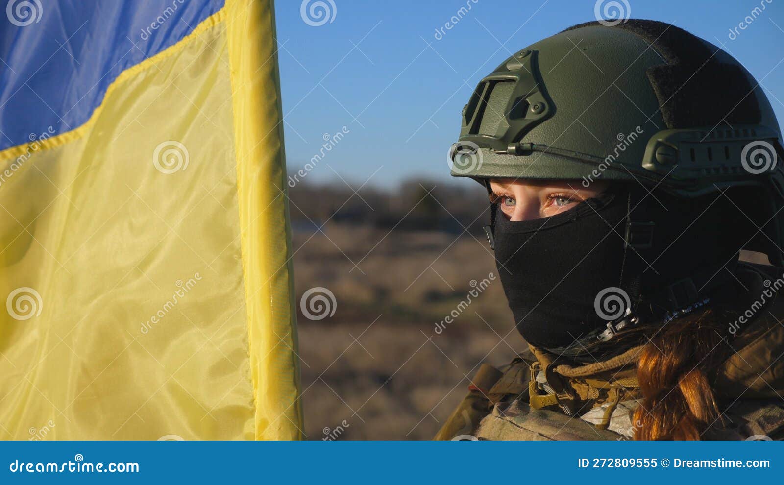 Dolly Shot of Girl in Military Helmet and Balaclava Holds a Waving ...