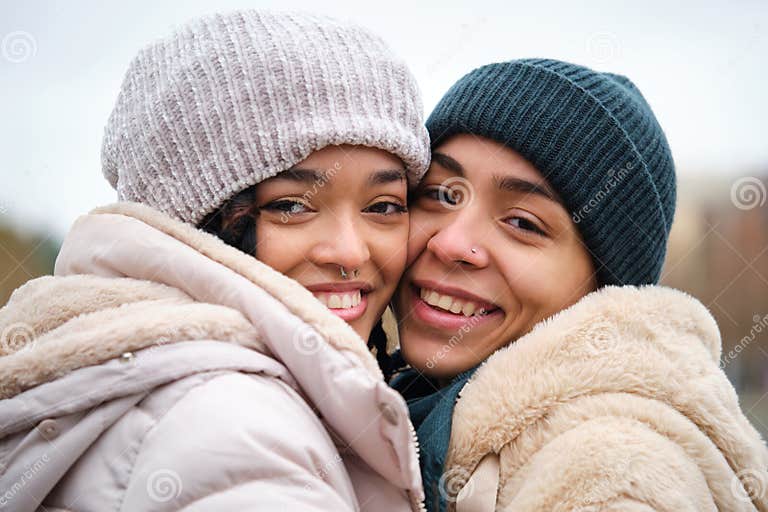 Dominican Lesbian Couple Hugging With Affection And Love At Street In