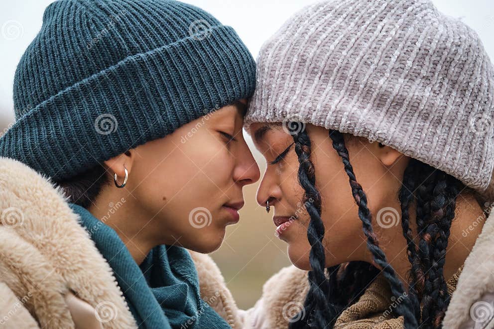 Dominican Lesbian Couple Showing Affection And Love At Street In Winter