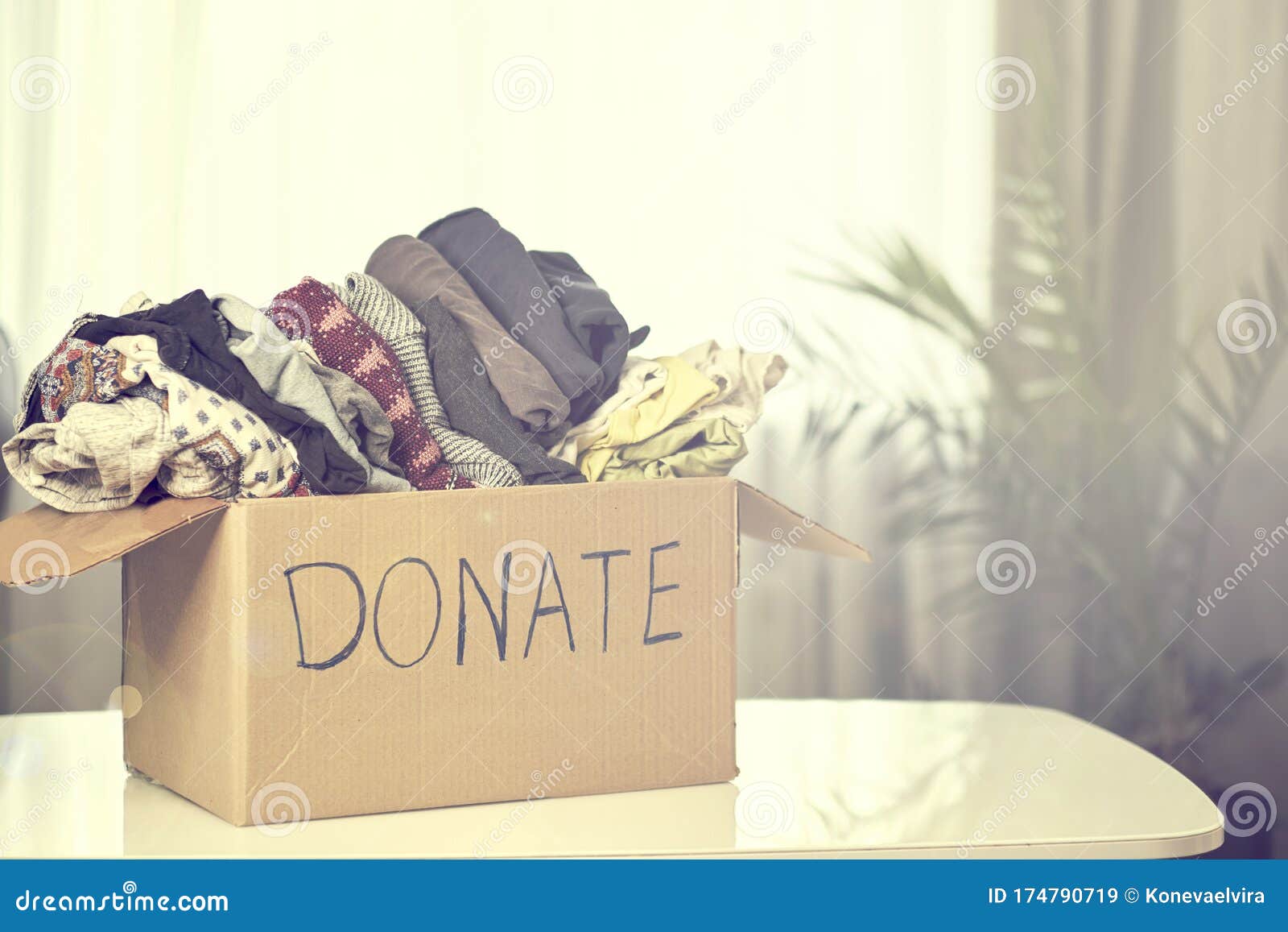 Donation Box with Clothing on the Table. Garage Sale, Second Hand Stock