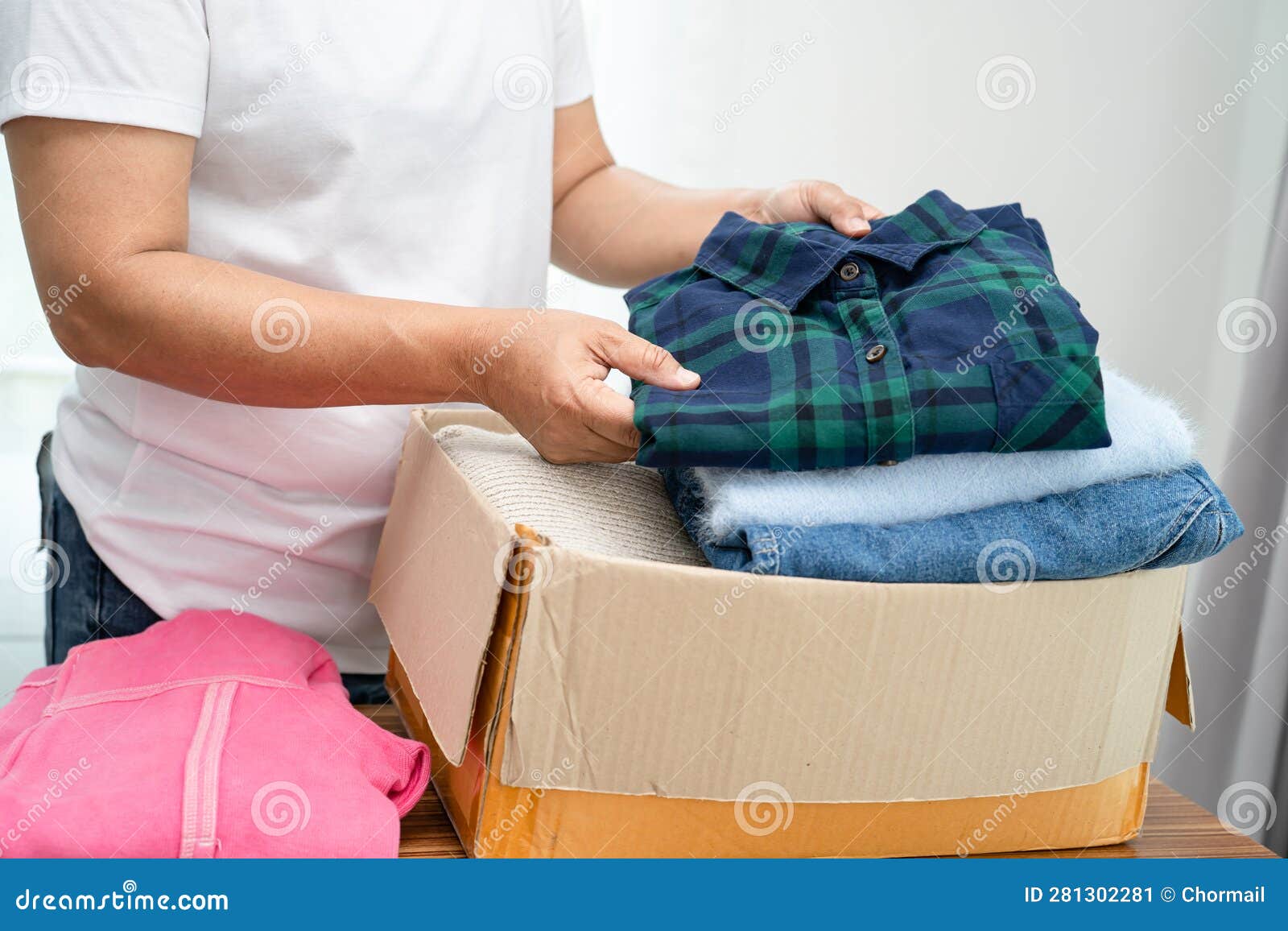 Donation Box with Used Clothes at Home To Support Help for Poor People