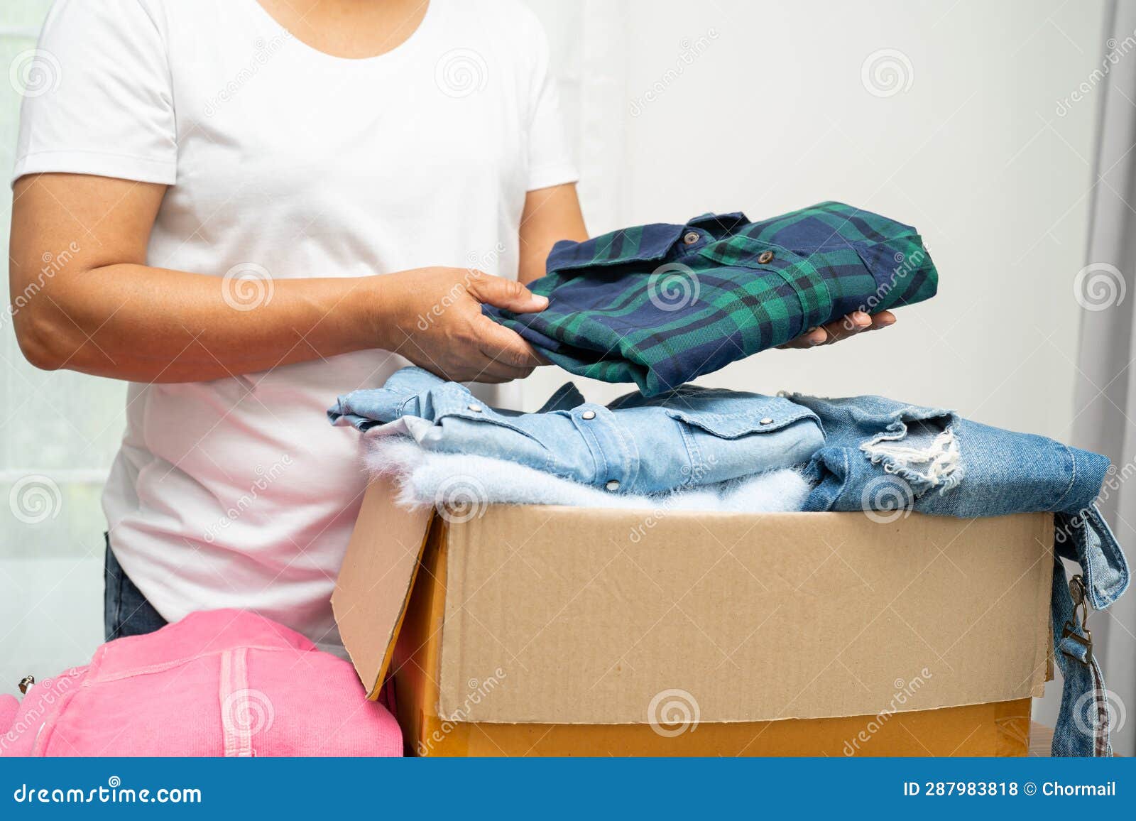 Donation Box with Used Clothes at Home To Support Help for Poor People