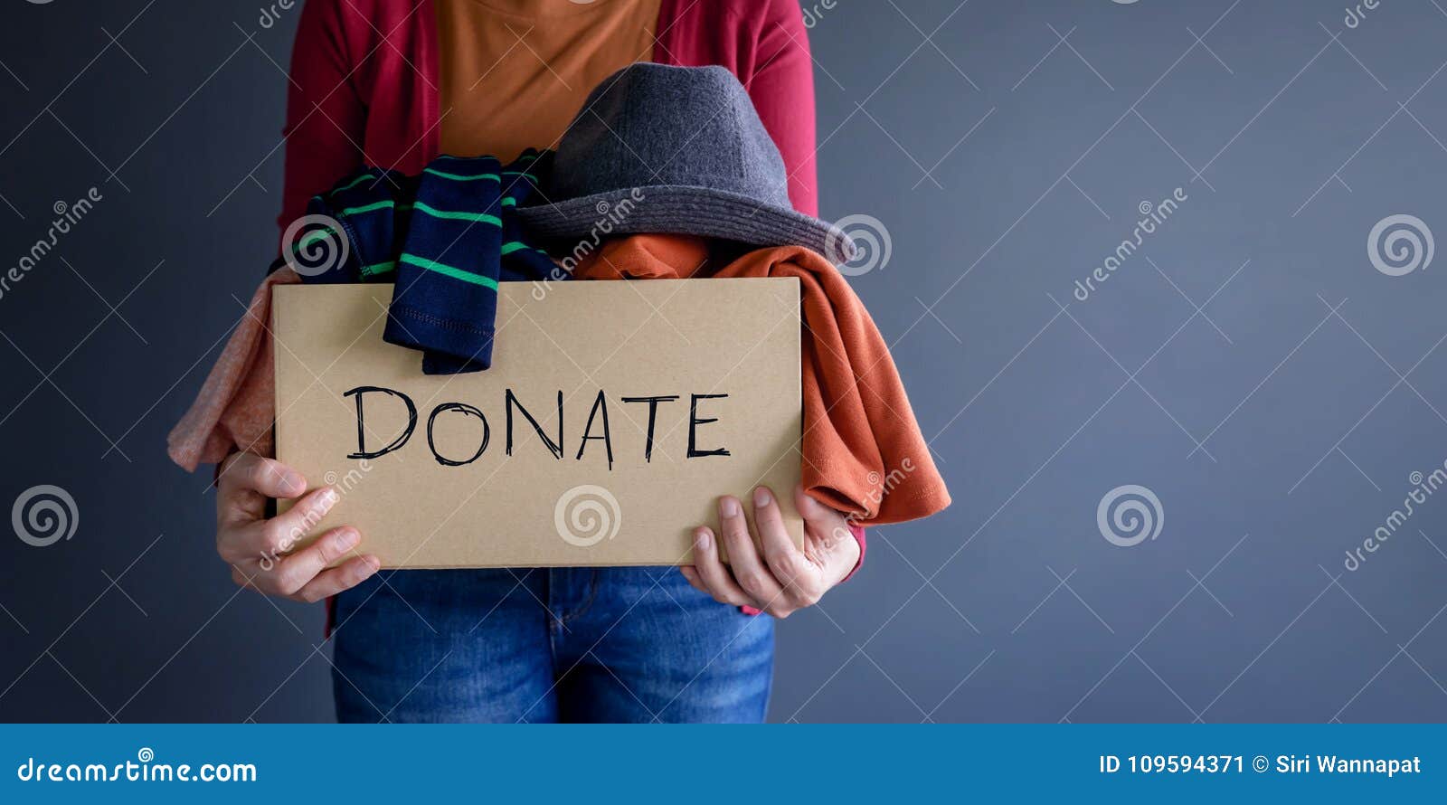 donation concept. woman holding a donate box with full of clothe