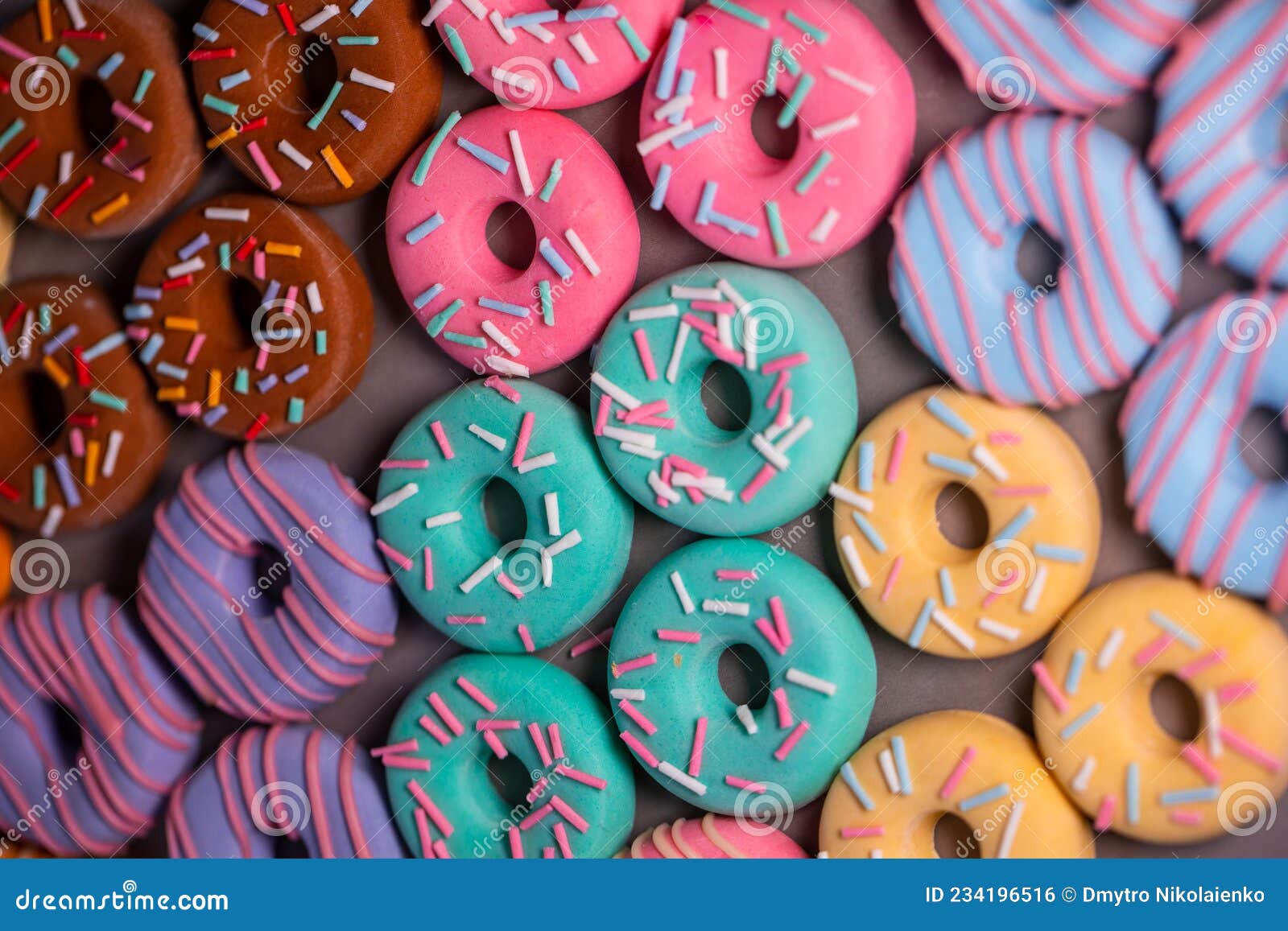 donats from sugar paste. multi-colored sugar art cakes. different types of colorful donats decorated sprinkles and icing. cake art