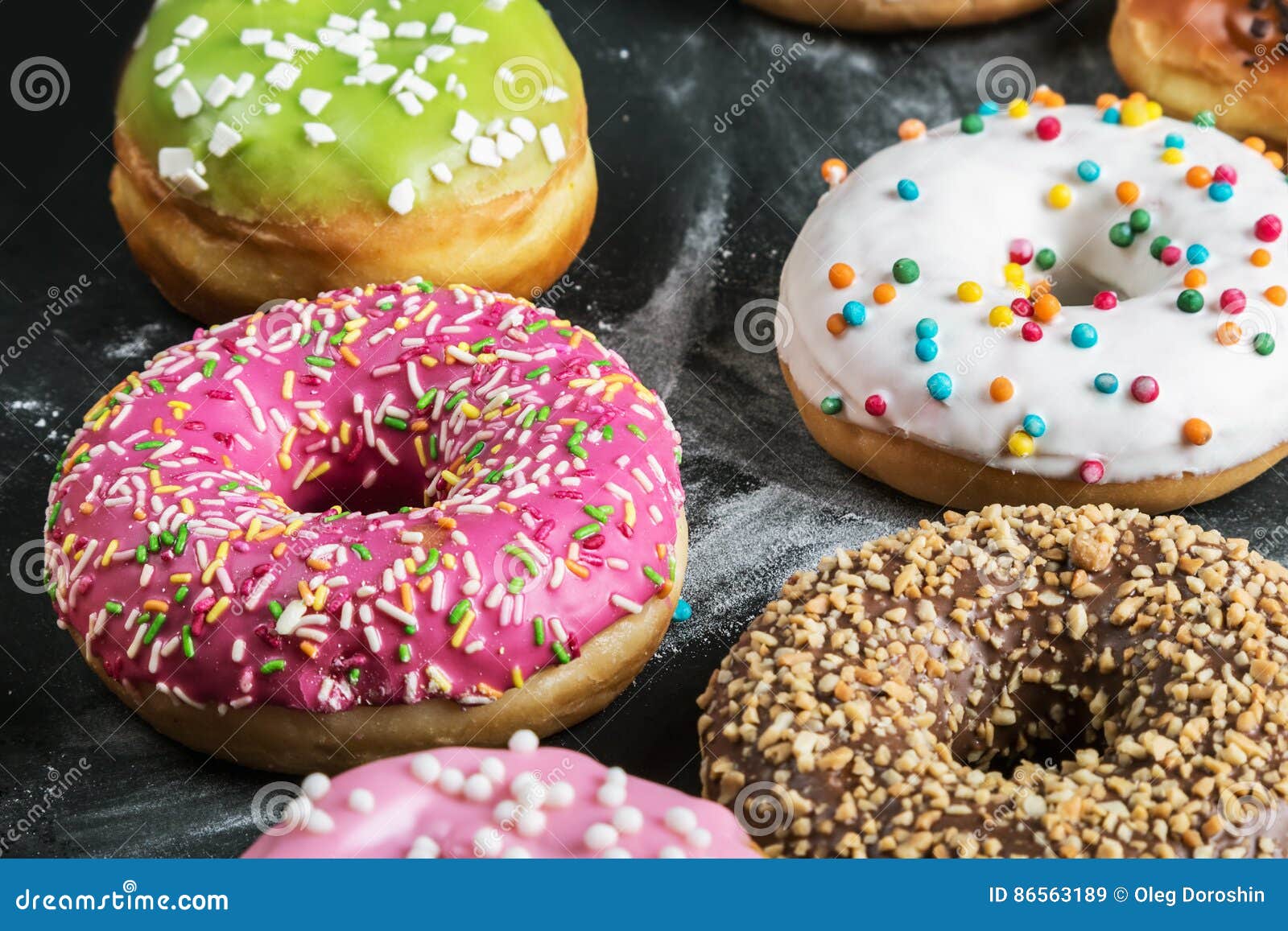 Donuts with Different Fillings on a Black Background Stock Image