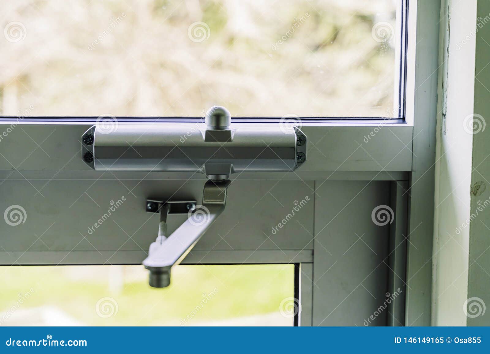 door closer on glass door on building entrace