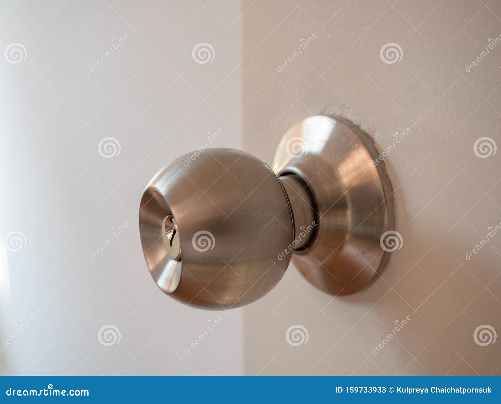 door knob,on wood white door,material stainless,beautiful lighting,sunlight,security lock,closeup detail