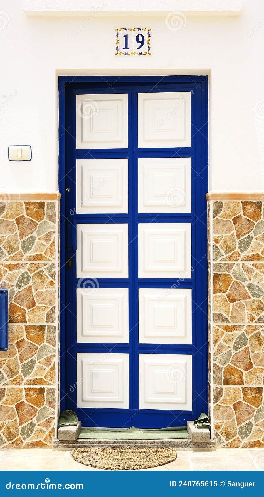 door with white squares framed in blue in a building in la graciosa