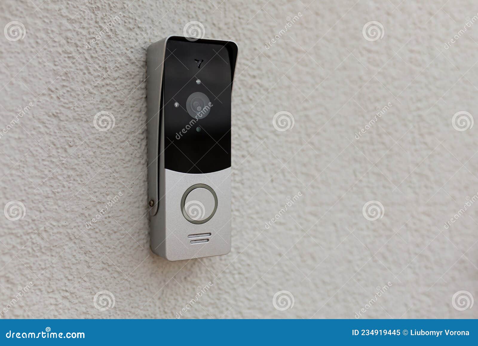 Doorbell on the Wall of the House with a Surveillance Camera Stock