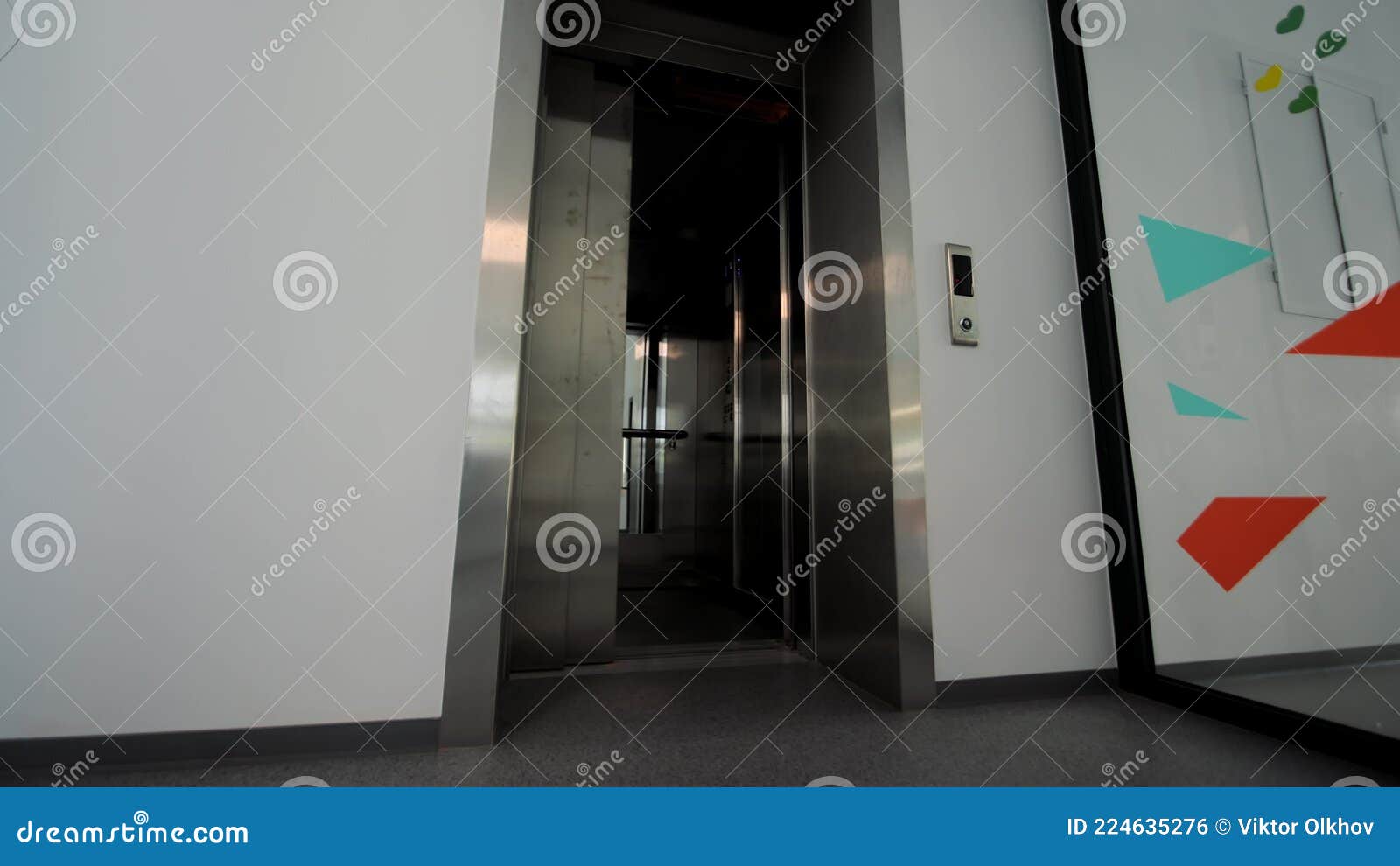 The Doors of the Office Elevator Close. the Passenger Elevator is Empty