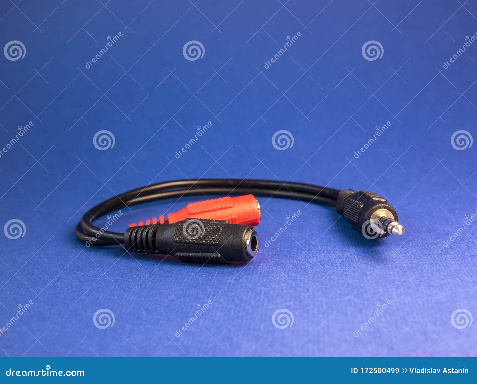 Double Adapter Under Headphones on a Blue Background Stock Image