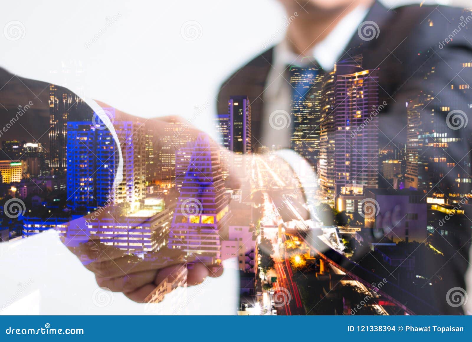 double exposure concept. investor business handshake with city night. businessman shaking hands