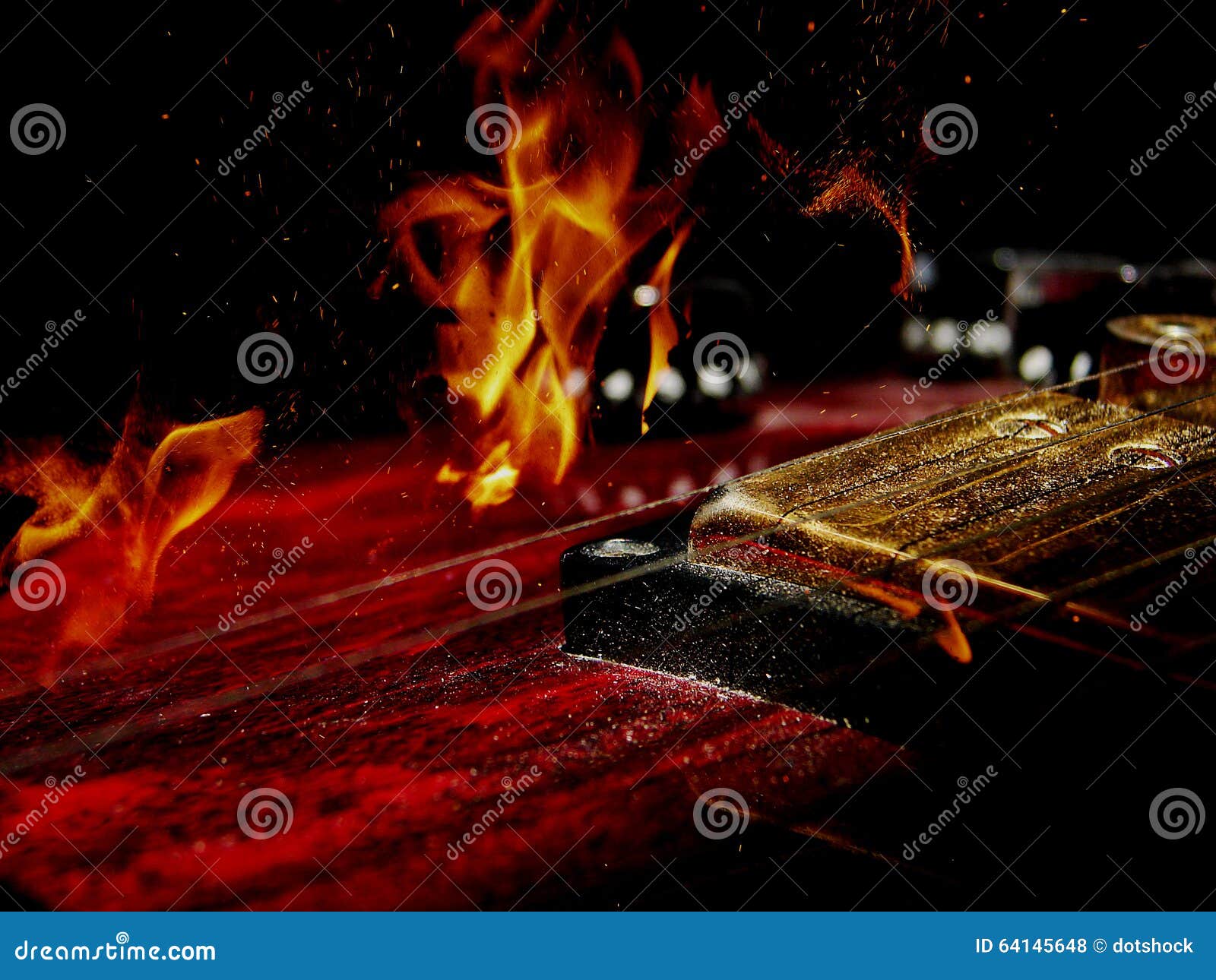 Double exposure electric guitar and fire. Double exposure of red electric guitar and fire flame isolated on black background in dark